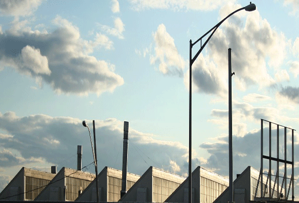 triangle roof building and streetlight against sky